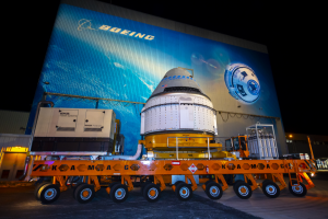 Nov. 21, 2019 - The Boeing CST-100 Starliner spacecraft rolls out from the company’s Commercial Crew and Cargo Processing Facility at NASA’s Kennedy Space Center in Florida. Credits: Boeing