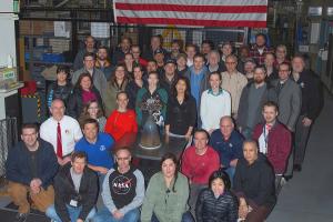 Members of Aerojet Rocketdyne’s Orion team in Redmond, WA, with one of the auxiliary engines for the Orion Artemis 2 European Service Module.