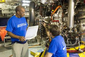 Technicians inspect the RS-25 controller (provides for comm between the SLS vehicle & the engine, relays commands to the engine, transmits data back to the SLS vehicle to regulate thrust & fuel mixture ratio & monitor the engine's health & status). 8/15